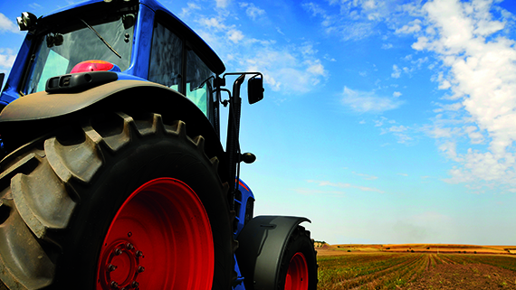 The Tractor - modern farm equipment in field